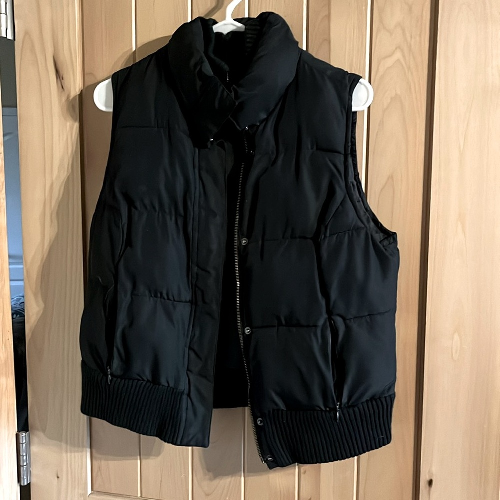 Black vest, slightly puffy.